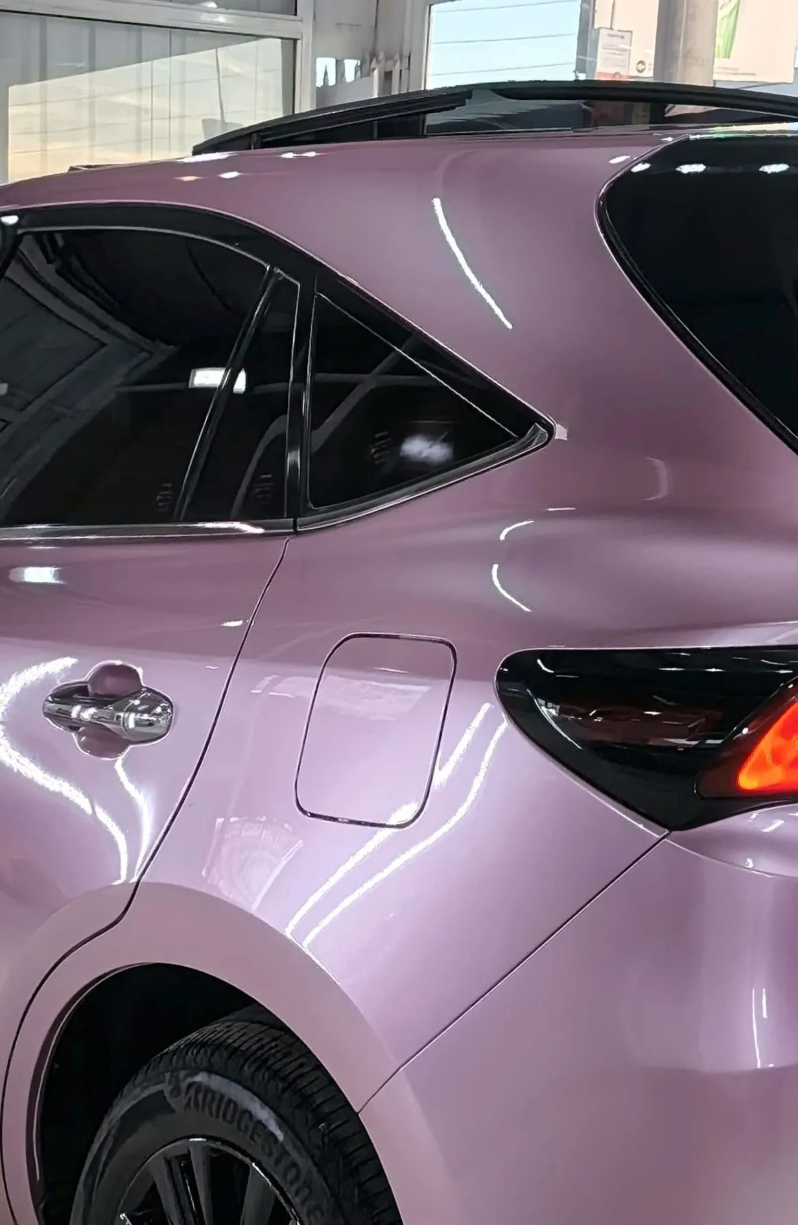 Close view of the rear quarter panel and tail light of a Toyota Harrier in gloss lavender